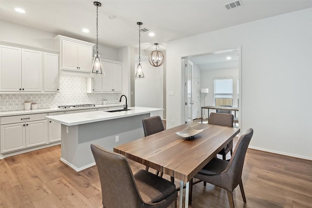 dining space with recessed lighting, light wood-style flooring, and visible vents