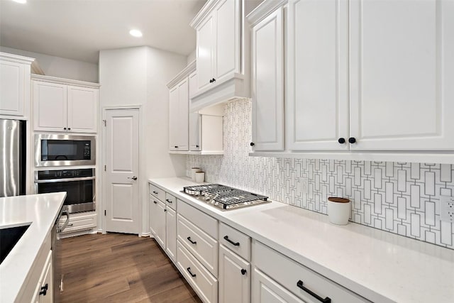 kitchen featuring light countertops, tasteful backsplash, white cabinetry, and stainless steel appliances