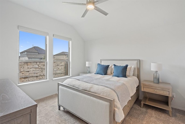 bedroom featuring lofted ceiling, a ceiling fan, baseboards, and light carpet
