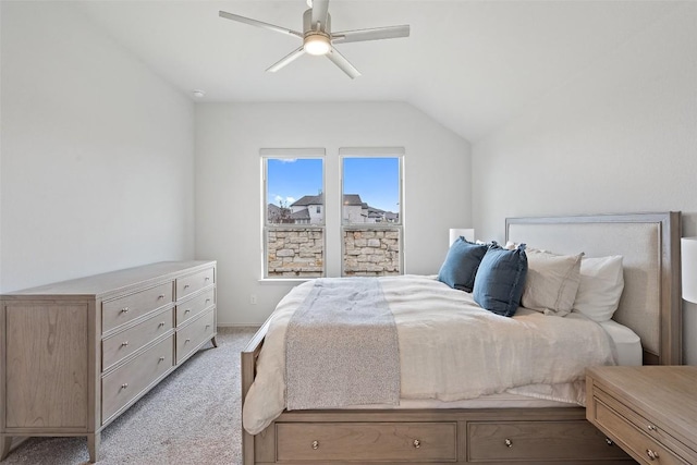 bedroom featuring lofted ceiling, light carpet, and a ceiling fan