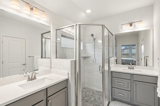 bathroom featuring a sink, a shower stall, and connected bathroom