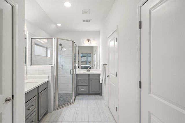 bathroom with a shower stall, visible vents, and vanity