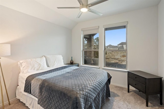 carpeted bedroom with baseboards, a ceiling fan, and vaulted ceiling