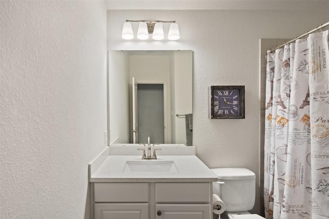 bathroom with curtained shower, a textured wall, toilet, and vanity
