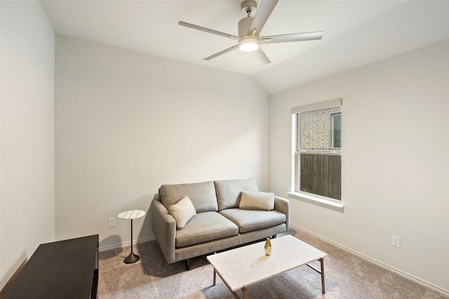 carpeted living area featuring a ceiling fan, baseboards, and vaulted ceiling