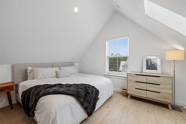 5701 Tura Ln Unit 1, Austin, TX 78721 - bedroom with light wood-style floors, vaulted ceiling, and a skylight