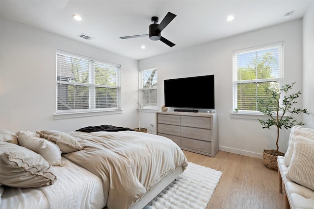 5701 Tura Ln Unit 1, Austin, TX 78721 - bedroom with multiple windows, light wood-style flooring, a ceiling fan, and recessed lighting