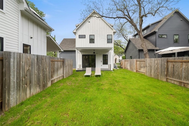 5701 Tura Ln Unit 1, Austin, TX 78721 - rear view of property featuring board and batten siding and a fenced backyard