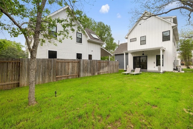 5701 Tura Ln Unit 1, Austin, TX 78721 - rear view of house with board and batten siding and a fenced backyard