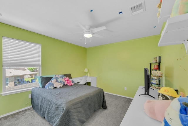 carpeted bedroom featuring baseboards, a ceiling fan, and visible vents
