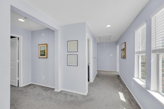 corridor featuring baseboards, recessed lighting, attic access, and carpet