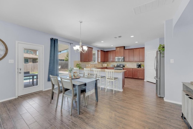 5812 Pescia St, Round Rock, TX 78665 - dining space featuring wood finished floors, a chandelier, baseboards, and recessed lighting