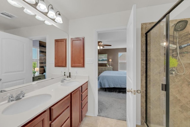 5812 Pescia St, Round Rock, TX 78665 - ensuite bathroom featuring double vanity, a shower stall, tile patterned flooring, and a ceiling fan