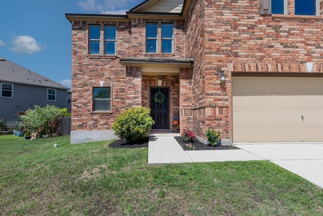 5812 Pescia St, Round Rock, TX 78665 - view of front facade featuring a front lawn, brick siding, driveway, and an attached garage