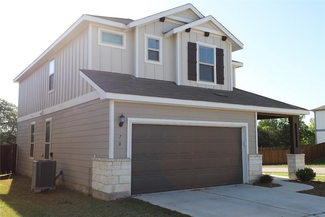 70 Snowy Plover Ln, Leander, TX 78641 - view of front of property featuring board and batten siding, a garage, central AC unit, and driveway