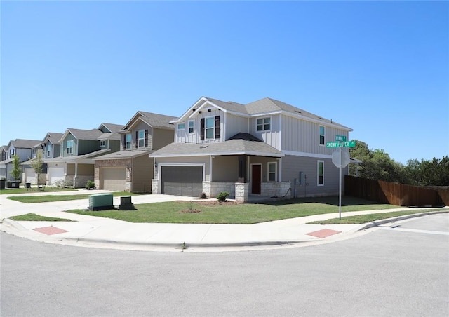 70 Snowy Plover Ln, Leander, TX 78641 - view of property featuring a garage, board and batten siding, concrete driveway, a residential view, and stone siding