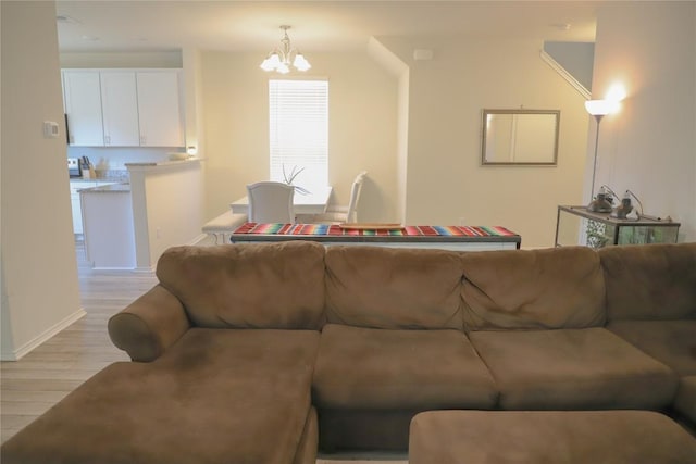 70 Snowy Plover Ln, Leander, TX 78641 - living area featuring light wood-style floors, a chandelier, and baseboards