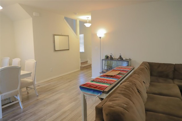 70 Snowy Plover Ln, Leander, TX 78641 - living area with light wood-style flooring, stairway, and baseboards