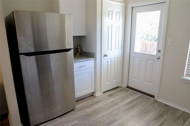 70 Snowy Plover Ln, Leander, TX 78641 - doorway to outside featuring light wood finished floors and baseboards