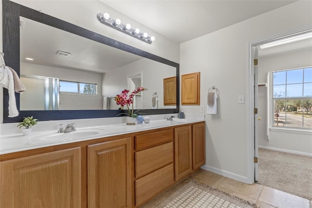 full bathroom with a sink, a shower with shower door, double vanity, and visible vents