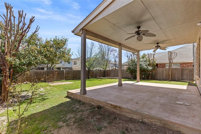 view of yard featuring a fenced backyard, ceiling fan, and a patio area