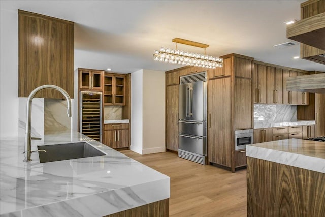 6304 Lost Horizon Dr, Austin, TX 78759 - kitchen featuring high quality fridge, wine cooler, light stone countertops, backsplash, and recessed lighting