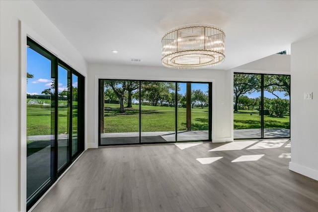 6304 Lost Horizon Dr, Austin, TX 78759 - unfurnished dining area with wood finished floors, baseboards, a chandelier, and recessed lighting