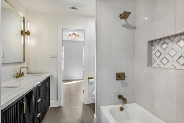 6304 Lost Horizon Dr, Austin, TX 78759 - full bathroom with wood finished floors, double vanity, tub / shower combination, and toilet