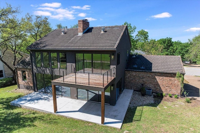 6304 Lost Horizon Dr, Austin, TX 78759 - back of house with a patio, a chimney, a lawn, a tiled roof, and brick siding