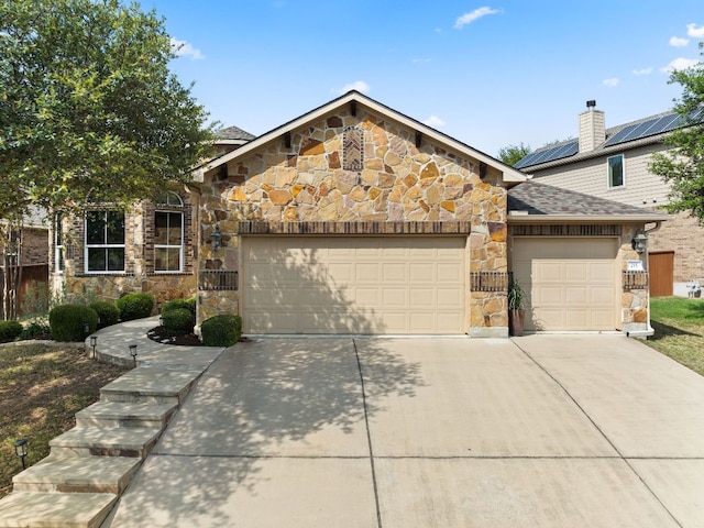 215 Choke Canyon Ln, Georgetown, TX 78628 - view of front facade with stone siding, a garage, concrete driveway, and a chimney