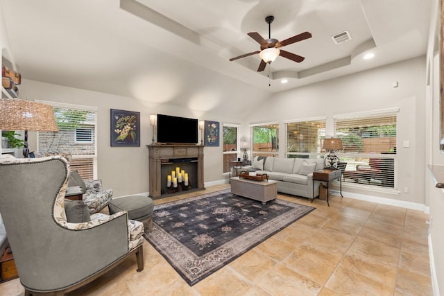 215 Choke Canyon Ln, Georgetown, TX 78628 - living area featuring a ceiling fan, recessed lighting, a tray ceiling, a fireplace, and a high ceiling