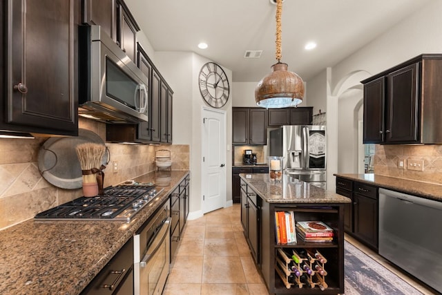 215 Choke Canyon Ln, Georgetown, TX 78628 - kitchen with appliances with stainless steel finishes, dark stone countertops, decorative backsplash, arched walkways, and open shelves