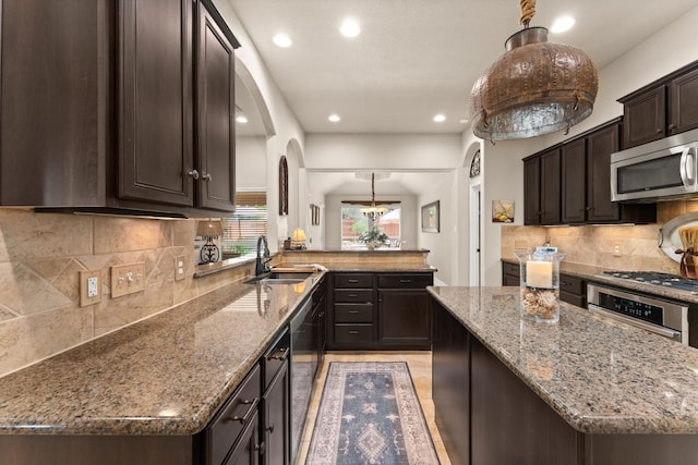 215 Choke Canyon Ln, Georgetown, TX 78628 - kitchen featuring appliances with stainless steel finishes, dark brown cabinetry, stone countertops, recessed lighting, and backsplash