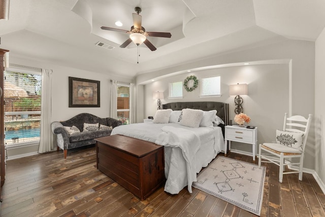 215 Choke Canyon Ln, Georgetown, TX 78628 - bedroom featuring dark wood finished floors, a raised ceiling, and ceiling fan