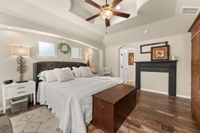 215 Choke Canyon Ln, Georgetown, TX 78628 - bedroom featuring hardwood / wood-style floors, a tray ceiling, ceiling fan, recessed lighting, and a fireplace