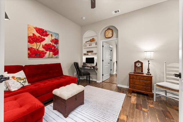 215 Choke Canyon Ln, Georgetown, TX 78628 - living area featuring hardwood / wood-style flooring, built in shelves, ceiling fan, and an office area