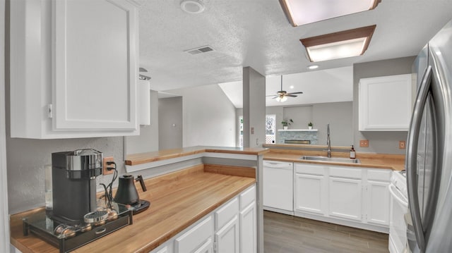 812 Saunders Dr, Round Rock, TX 78664 - kitchen with white appliances, ceiling fan, a fireplace, and white cabinetry
