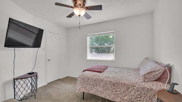 812 Saunders Dr, Round Rock, TX 78664 - carpeted bedroom with a textured ceiling and a ceiling fan