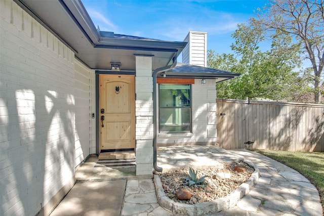 812 Saunders Dr, Round Rock, TX 78664 - view of exterior entry with a chimney and roof with shingles