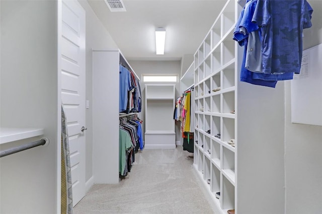 spacious closet featuring visible vents and carpet