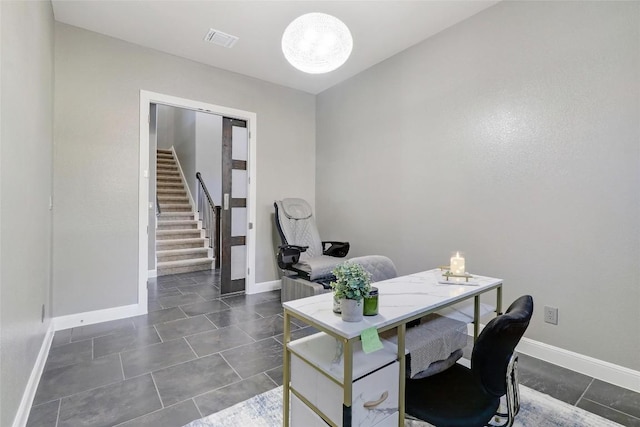office with visible vents, baseboards, dark tile patterned floors, and an inviting chandelier