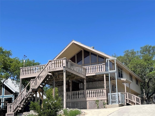 1530 Trailridge Dr, Canyon Lake, TX 78133 - view of front facade featuring stairs and a wooden deck