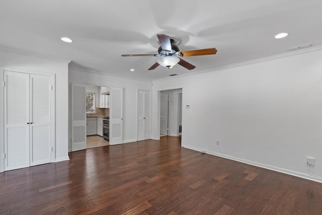 1905 Robinhood Trl, Austin, TX 78703 - unfurnished bedroom with two closets, ornamental molding, recessed lighting, dark wood-type flooring, and ceiling fan