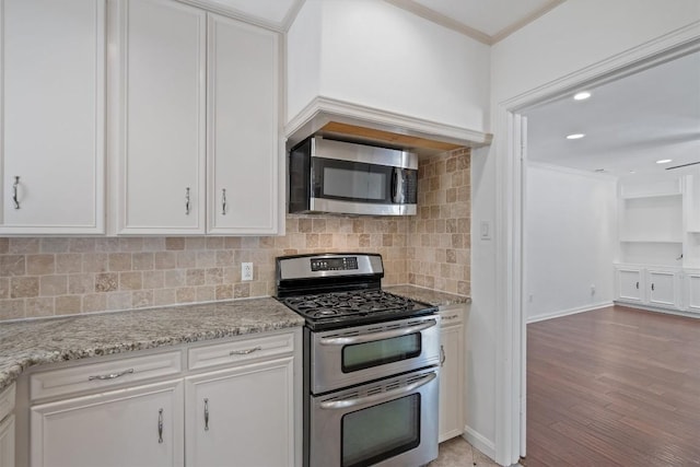 1905 Robinhood Trl, Austin, TX 78703 - kitchen with appliances with stainless steel finishes, ornamental molding, white cabinetry, tasteful backsplash, and light wood-type flooring