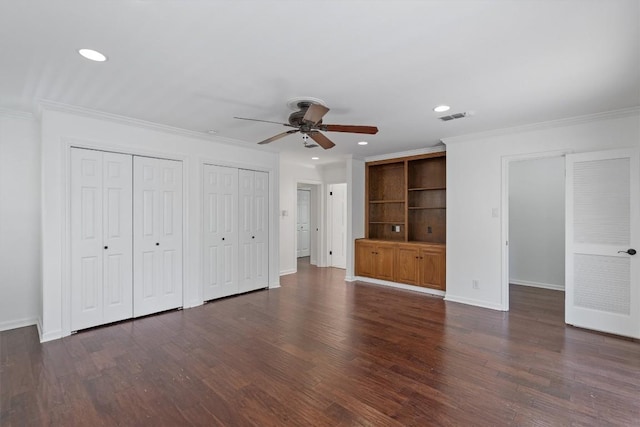 1905 Robinhood Trl, Austin, TX 78703 - unfurnished bedroom with recessed lighting, crown molding, dark wood-type flooring, multiple closets, and a ceiling fan