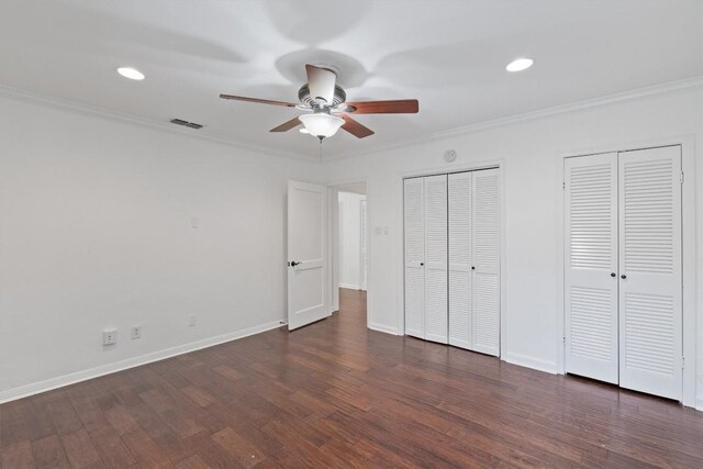 1905 Robinhood Trl, Austin, TX 78703 - unfurnished bedroom with two closets, ornamental molding, wood finished floors, recessed lighting, and ceiling fan