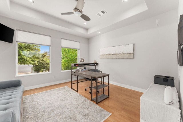 office area featuring baseboards, a ceiling fan, a tray ceiling, and recessed lighting