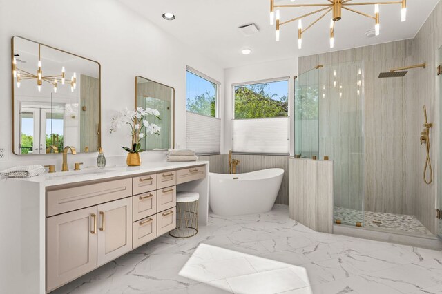 full bath with vanity, a freestanding tub, walk in shower, and a notable chandelier