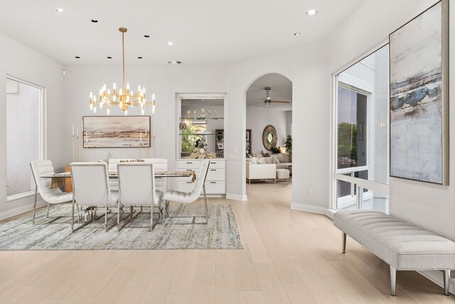 dining space featuring recessed lighting, visible vents, ceiling fan with notable chandelier, and light wood-type flooring