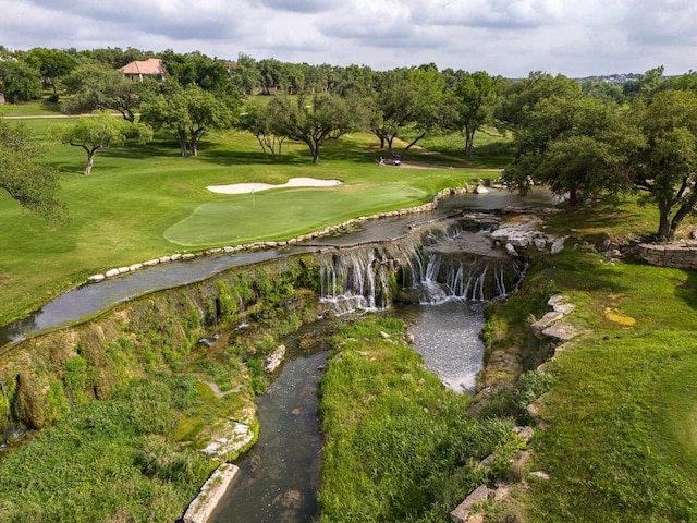 surrounding community with a lawn and golf course view